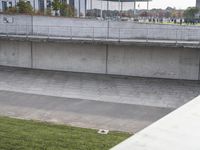 a man is standing on a ledge and using his cell phone to take pictures of the crowd