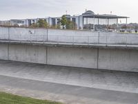 a man is standing on a ledge and using his cell phone to take pictures of the crowd