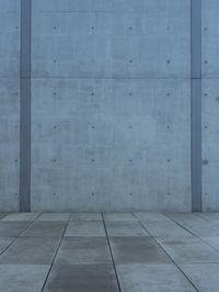an image of a street with concrete wall background and flooring on either side of it