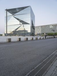 a view of the city and surrounding itself of the glass building, showing the entrance to a large city square