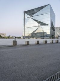 a view of the city and surrounding itself of the glass building, showing the entrance to a large city square