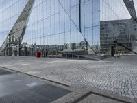 this is an image of the side walk in front of the glass walled office building