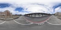 the 360 - eye view photo shows a curved street in a city near highrise apartment buildings