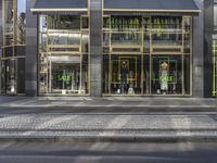 the corner of a street with shopfronts in a modern urban setting with shopfronts