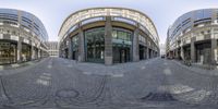 a 360 - view photo of an empty square at the end of a walkway in front of several buildings