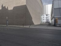 the intersection of an empty street and a building on the other side of the street