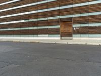 the side of a building with a large wood facade and a large fire hydrant outside