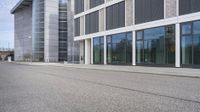 a man is riding his skateboard on the street in front of an office building