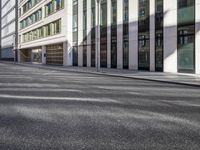 empty road with buildings on both sides in an urban setting on a clear day with no cloud coverage
