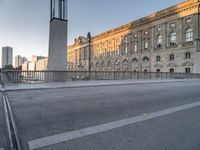 the large building has two clocks on it's side with buildings and a tall clock tower