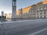 the large building has two clocks on it's side with buildings and a tall clock tower