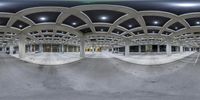 this 360 - view image looks out the entrance to a warehouse, which is part of an urban park