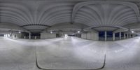 a fish - eye lens lens of an empty parking garage with a view of the ground outside