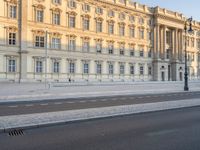 there is an empty street with a red bus next to the building on the side