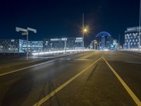 an empty road is lit up by cars at night time in this image taken from the roadway