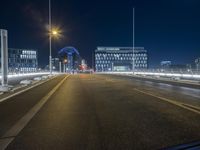 an empty road is lit up by cars at night time in this image taken from the roadway
