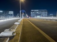 an empty road is lit up by cars at night time in this image taken from the roadway
