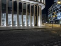 a photo taken at night of the outside of a building in an area with concrete