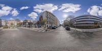 a street that has some cars and houses in it as an example for panoramic photography