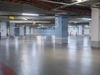 a parking garage with concrete floors and parking meters on each side of the space,