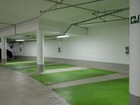 this is an image of a green garage area with white painted walls and concrete floors