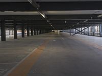 a parking garage is empty, it seems to be nightlife or outside there are no cars