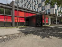 this photo is taken in a modern city area with red and black facade and windows