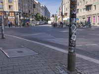 an image of a pole near some buildings in the street? for people to see