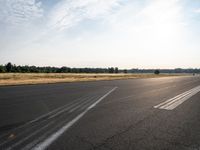 a road with pavement and the sunlight coming down over it to the right of it