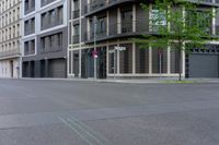 a man skateboarding on the street while traffic goes by in front of buildings,