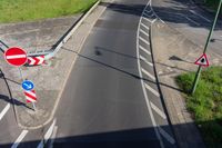 a road with two red and white signs on both sides of it at a curve