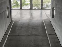 a couple of cement steps leading up to a floor that has a bunch of window with lots of glass on top