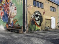 a street with painted buildings and a bird in the middle of it's face