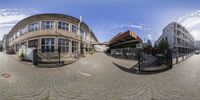 a fisheye view of a very beautiful and nice street and buildings that are surrounded by buildings