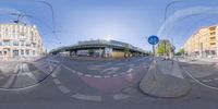 a view from inside a fish eye lens of the street intersection, looking straight ahead