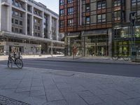 an image of a street scene looking at a bicycle parked on the curb side of it