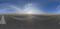 three different views of an empty runway on the side of a road at sunset with a bright blue sky