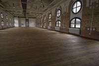 a large room with some windows and windows in it, and wood floors underneath it