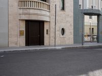 a motorcycle parked in front of a tall building on the street with its doors open
