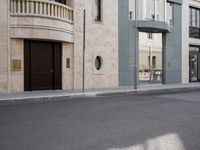 a motorcycle parked in front of a tall building on the street with its doors open