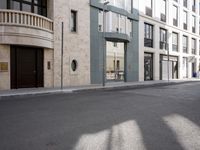 a motorcycle parked in front of a tall building on the street with its doors open