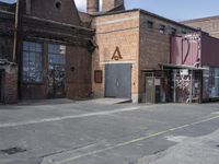 an empty parking lot with tall buildings in the background and a person on a scooter