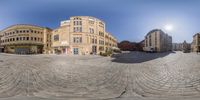 the view of a town center from the bottom of a big street corner with a building in the background