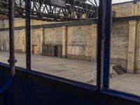 a view of the inside of a train station from the back of a bus driving by