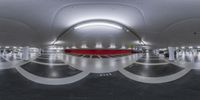 a circular photo in an underground space that is empty with the lights turned on and the floors