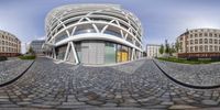 a 3d image of an unusual building made of bricks on the streets of europe with multiple circular views