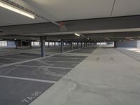 an empty parking lot with a lot of parking spaces on the floor, near large windows