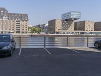 car park with view over bridge and buildings in urban area on clear day, day