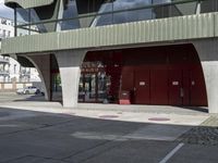 an empty building with an awning and fire hydrant underneath it on a street