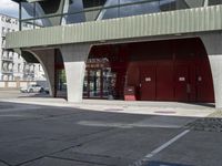 an empty building with an awning and fire hydrant underneath it on a street